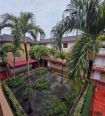 a backyard of a house with lots of green space and fountain