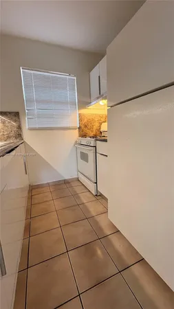 a view of kitchen with furniture and window
