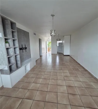 a view of a kitchen and an empty room
