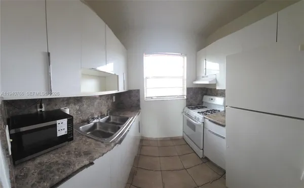 a kitchen with a sink a stove and refrigerator
