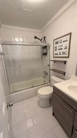 a bathroom with a toilet a sink and shower