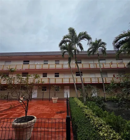 a balcony with furniture and a potted plant