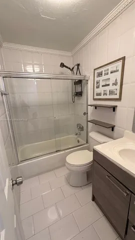 a bathroom with a toilet a sink and shower