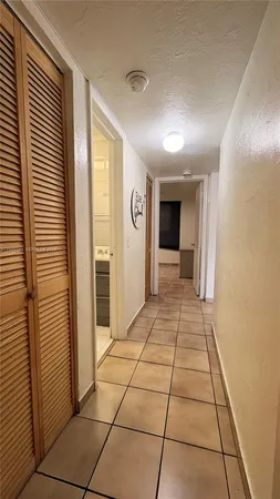 a view of a hallway with wooden shelves