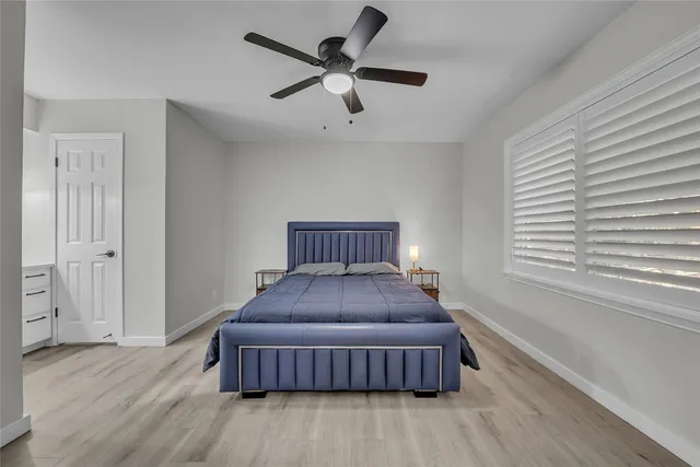 a bedroom with a bed and window