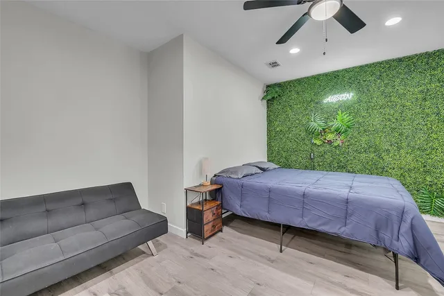 a bed room with a bed and a television