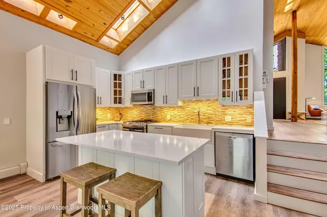 a kitchen with refrigerator and cabinets