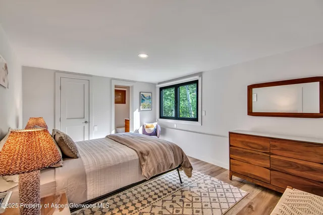 a bedroom with a bed and dresser