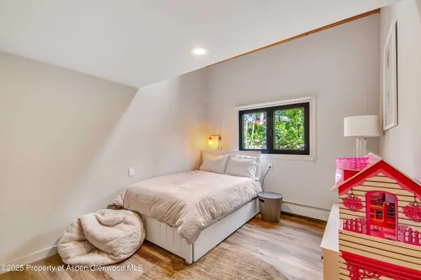 a bedroom with a bed and a painting on the wall