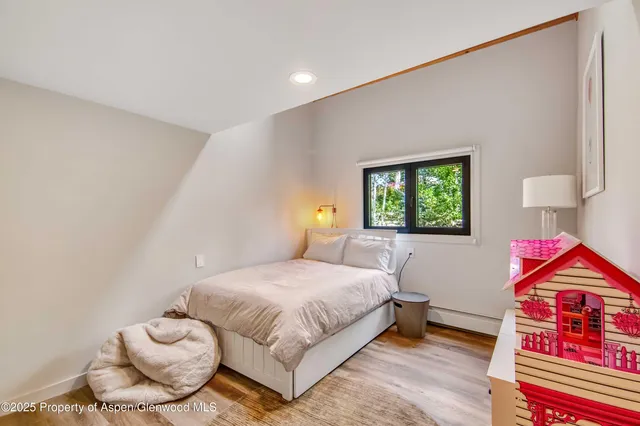 a bedroom with a bed and a painting on the wall