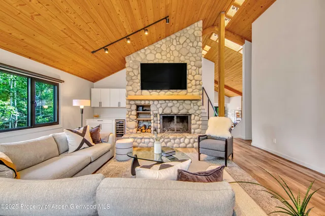 a living room with fireplace furniture and a flat screen tv
