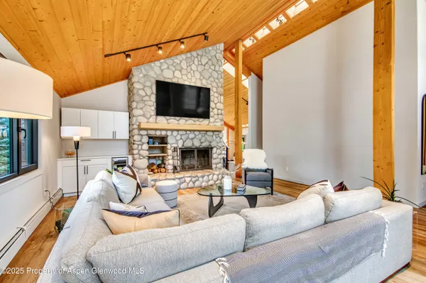 a living room with furniture a fireplace and a flat screen tv