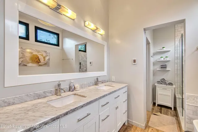 a bathroom with a granite countertop sink mirror and a