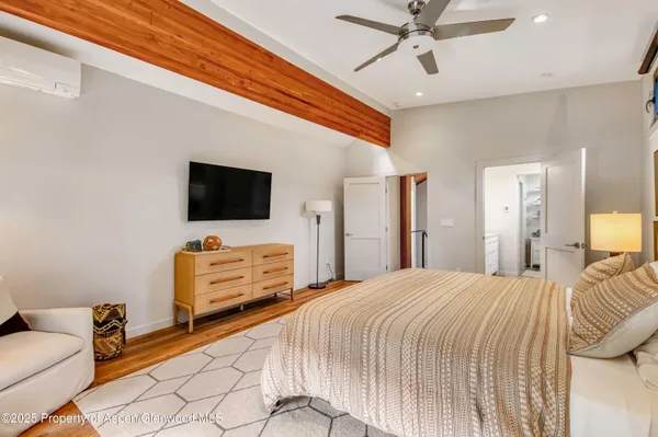 a bedroom with a bed and flat screen tv