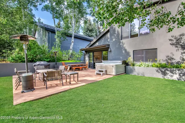 a view of a house with a yard and sitting area