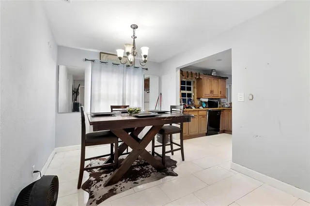 a view of a dining room with furniture and a chandelier
