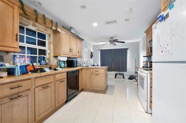 a kitchen with a refrigerator and a sink