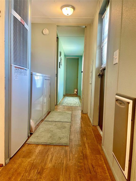 2334 San Bar Road, Unit 96 Graford, TX 76449 - Photo 13 of 40 Past the laundry area is a renovated split bunkroom and a large bathroom with nearly new oversized shower. All can be closed off with the door located in the hall to allow privacy for the early to bed or late to rise visitors.
