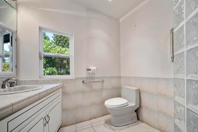 a bathroom with a toilet sink and mirror