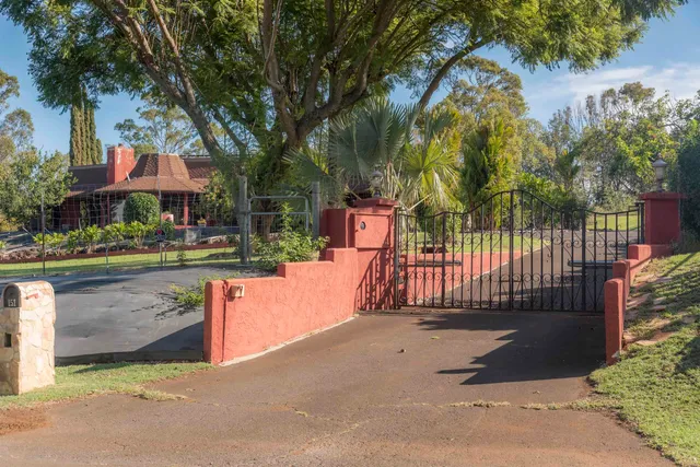 a view of a park with iron fence