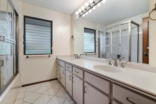 a bathroom with a double vanity sink and a mirror