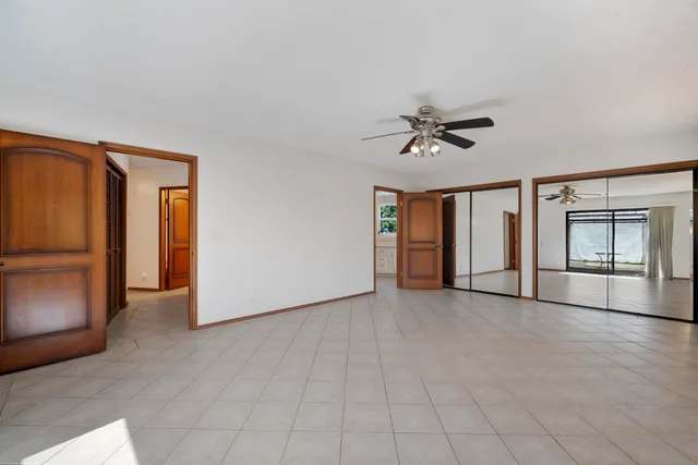 an empty room with windows and closet