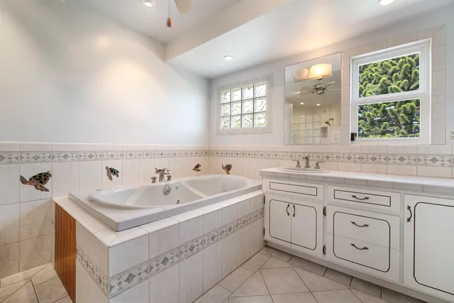 a spacious bathroom with a sink double vanity and windows