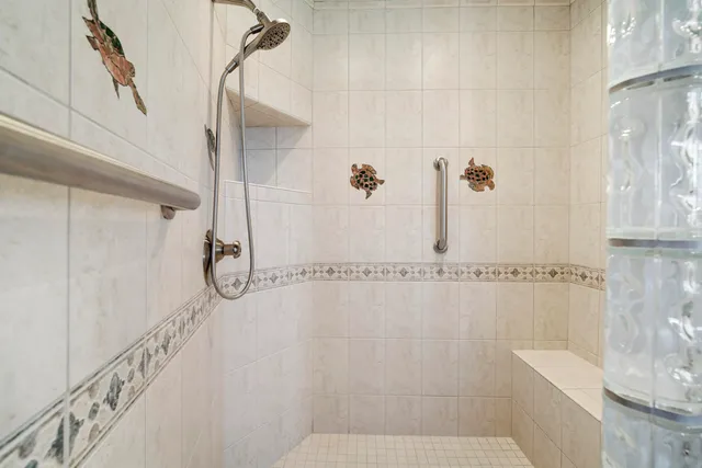 a bathroom with a shower and a glass door
