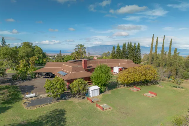 a view of a garden with a building in the background