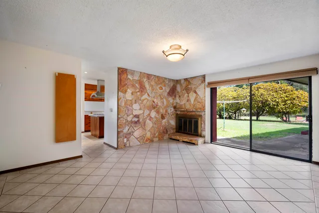 a view of a livingroom with a fireplace and window
