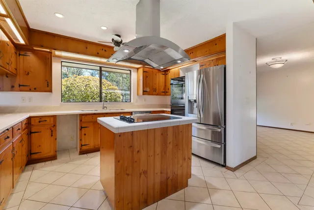 a kitchen with stainless steel appliances granite countertop a refrigerator and a sink