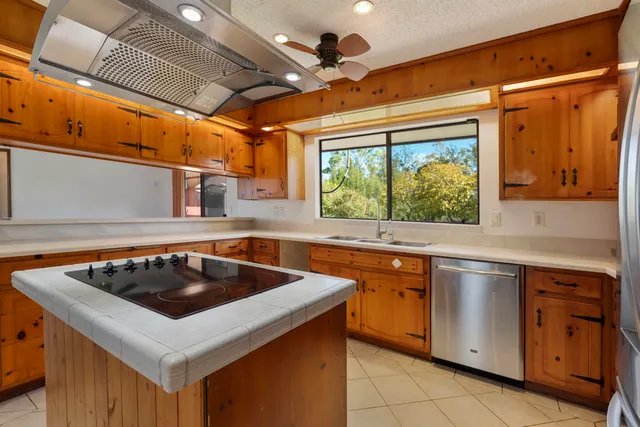 a kitchen that has a sink and a stove in it
