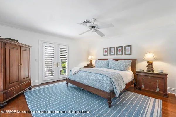 a spacious bedroom with a bed and wooden floor