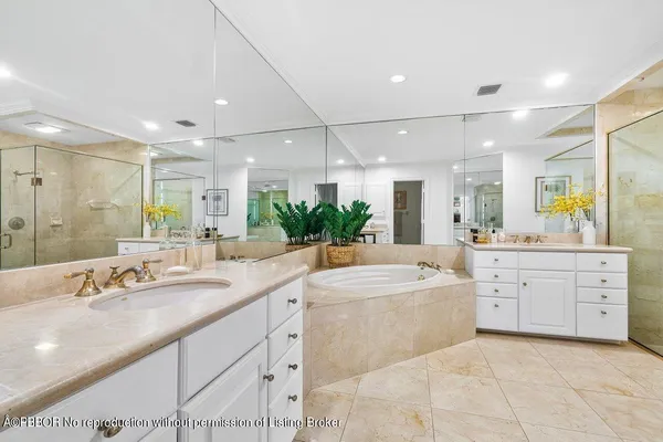 a large bathroom with a large mirror vanity and shower