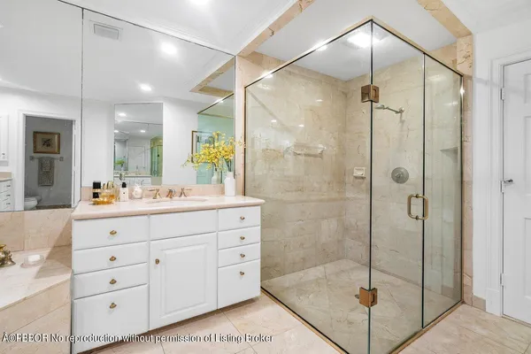 a bathroom with a shower sink and mirror