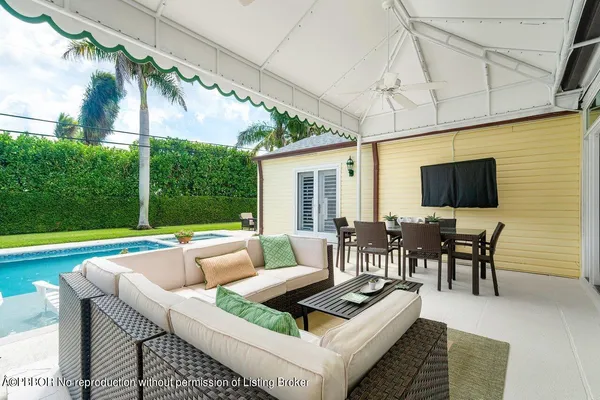 a view of a patio with couches chairs dining table and chairs with wooden floor