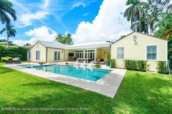 a view of house with swimming pool and porch