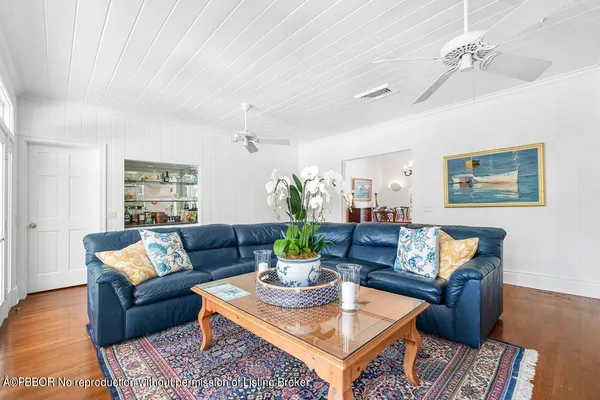 a living room with furniture and a dining table