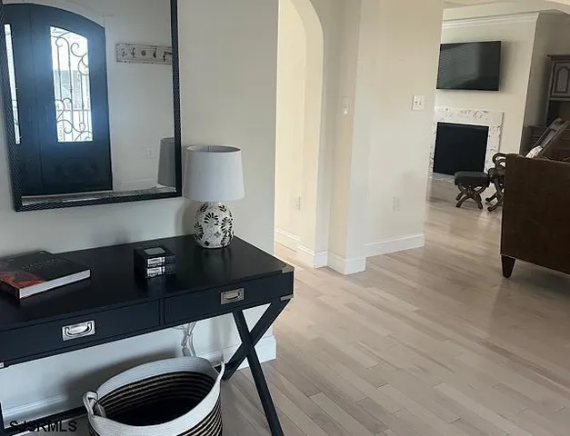 a view of a workspace with furniture and wooden floor
