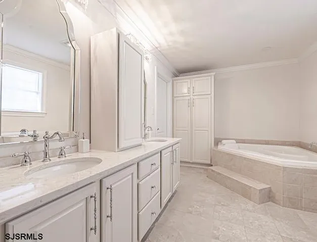 a bathroom with a double vanity sink and mirror with bathtub