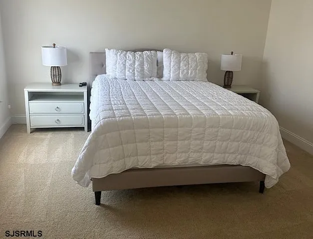 a bedroom with a bed and lamp