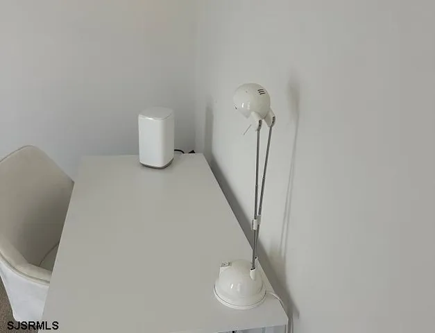 a bathroom with a granite countertop sink a toilet and a mirror
