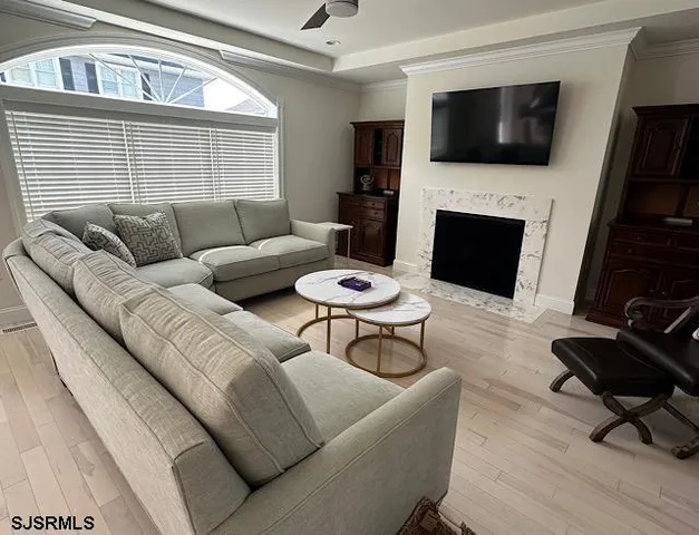 a living room with furniture a flat screen tv and a fireplace