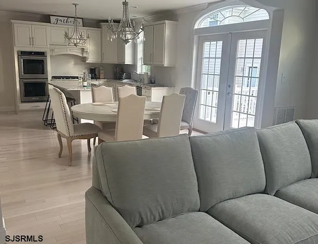 a living room with furniture and a chandelier