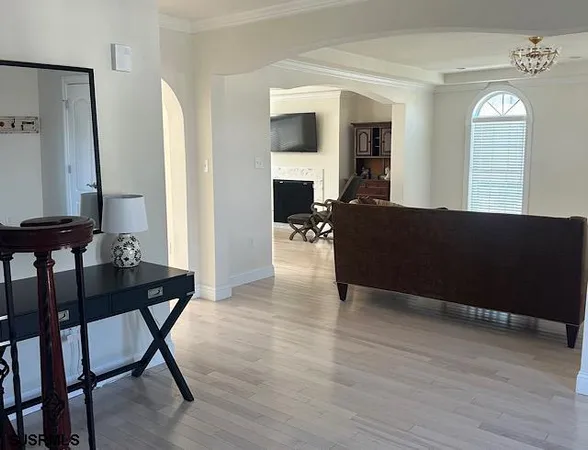 a view of entryway and hall with wooden floor