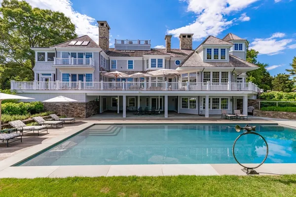 a front view of a house with swimming pool having outdoor seating