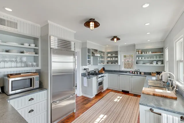 a kitchen with refrigerator and stove