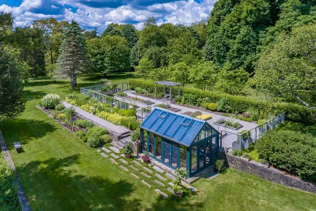an aerial view of a house with a yard basket ball court and outdoor seating