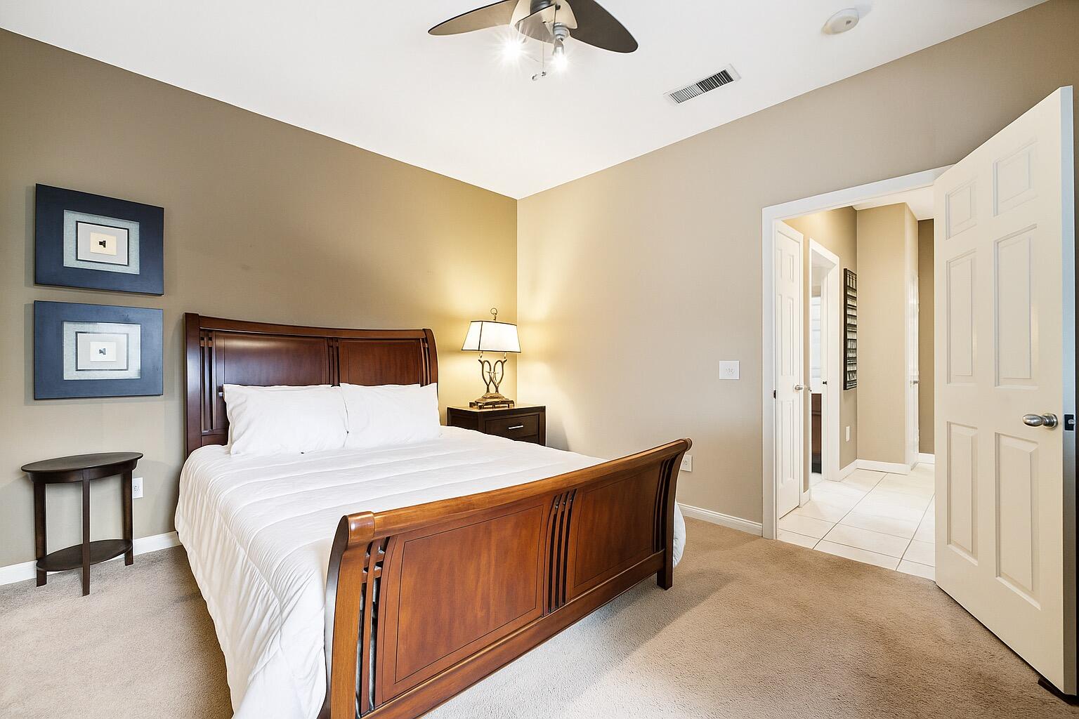 49151 Biery Street Indio, CA 92201 - Photo 17 of 26 a bedroom with a bed and a chandelier