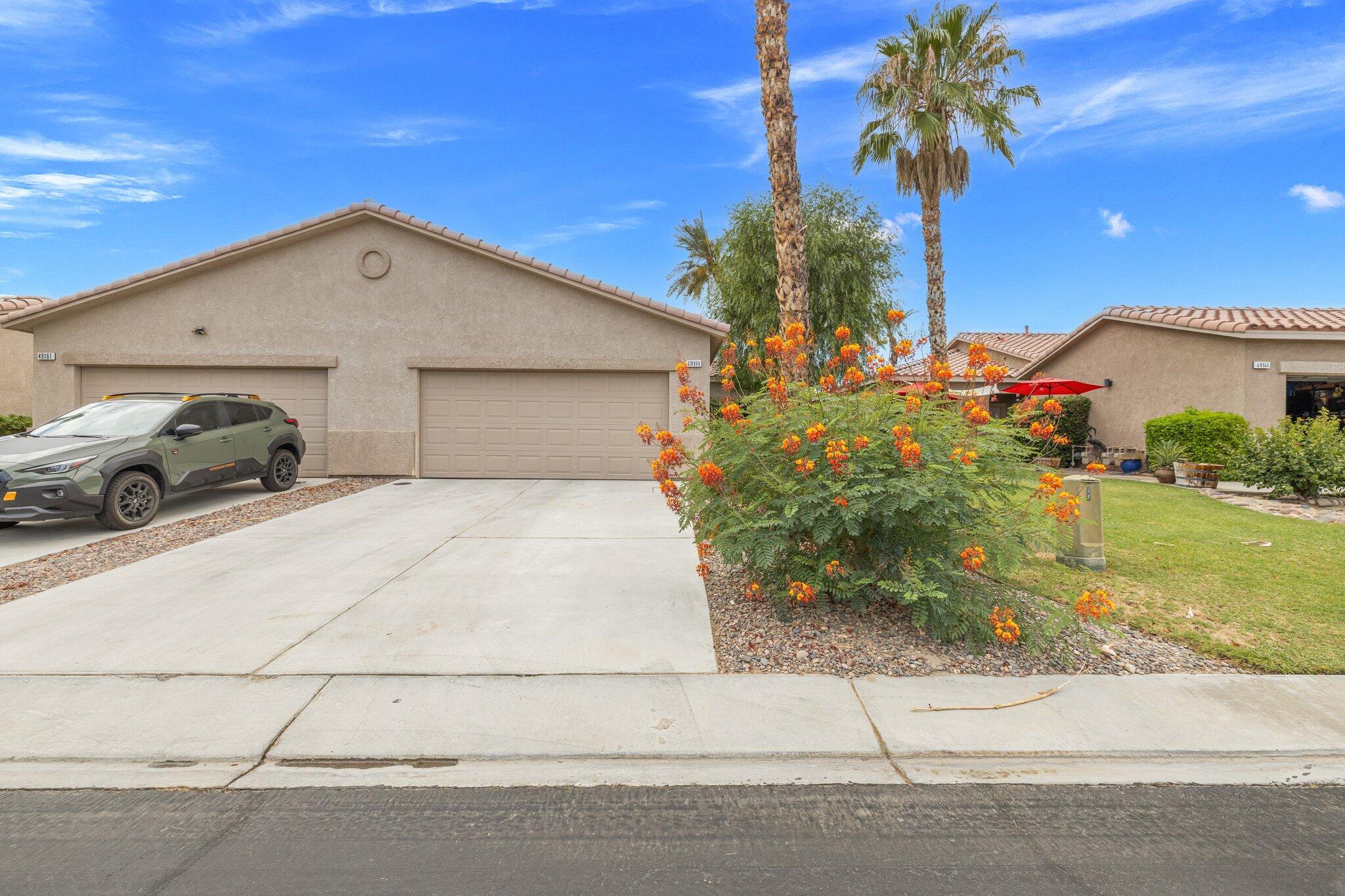 49151 Biery Street Indio, CA 92201 - Photo 6 of 26 a view of a white house with a yard